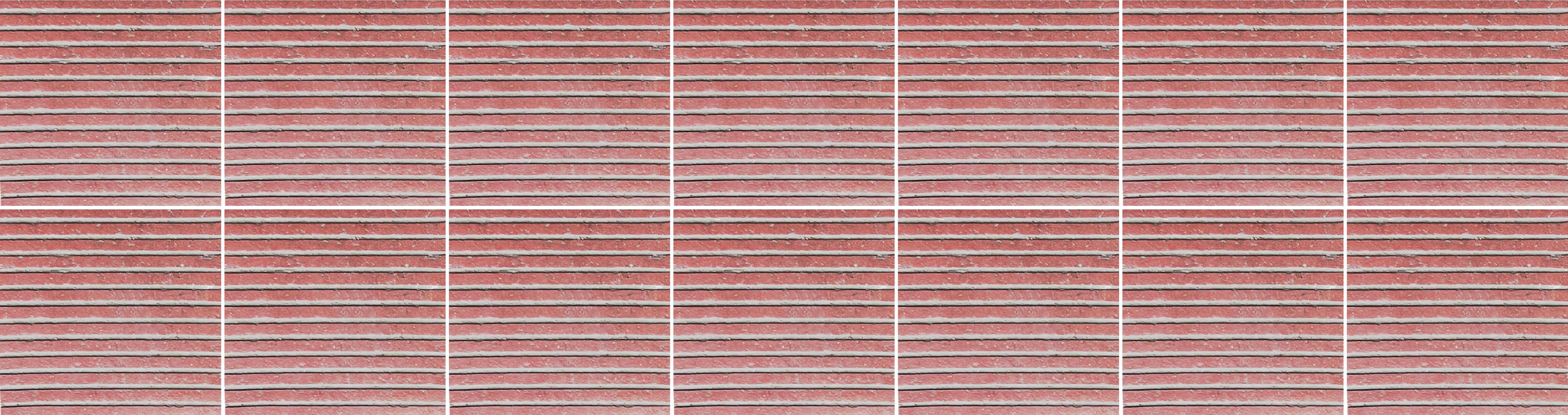 거친 질감에 촘촘한 흰색 줄무늬가 있는 붉은 색의 벽돌 타일들로 이루어진 사진이다.